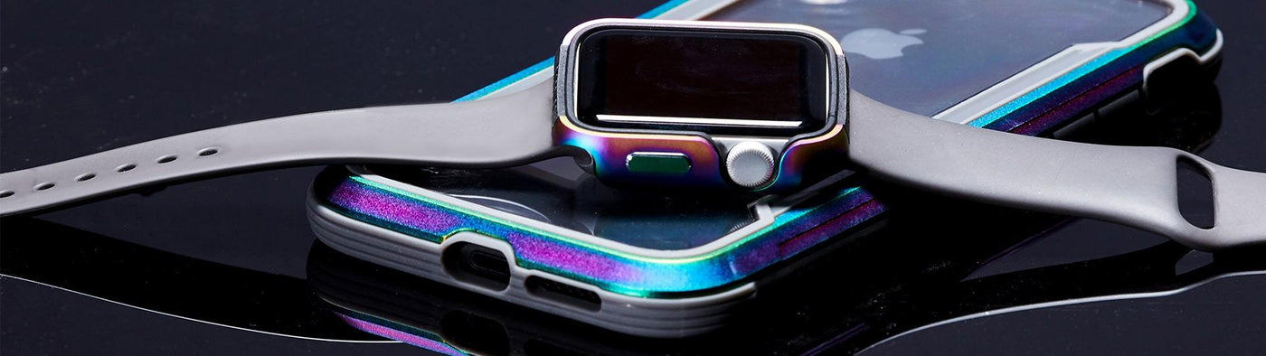 Raptic™ bumper case on an Apple Watch laying accross an iPhone.