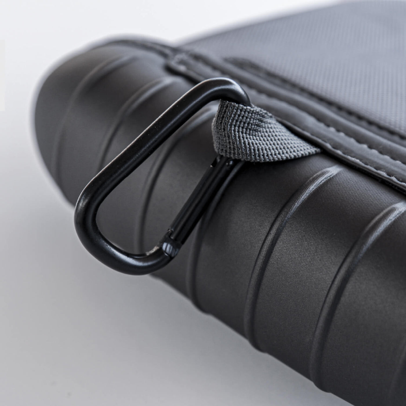 Close up of the back of Smarform Case showing the loop with a black carabiner attached.